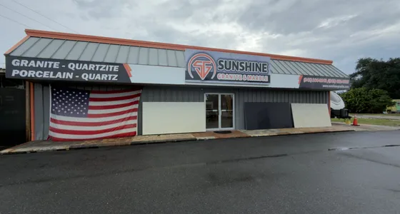 Sunshine Granite & Marble storefront with the granite, quartzite, porcelain and quartz sign
