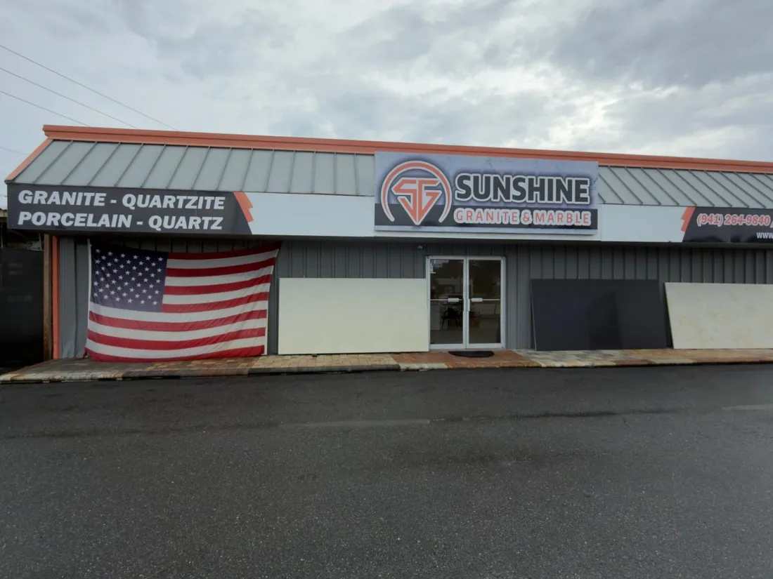Front of the Sunshine Granite & Marble showroom and stone shop seen from the parking lot